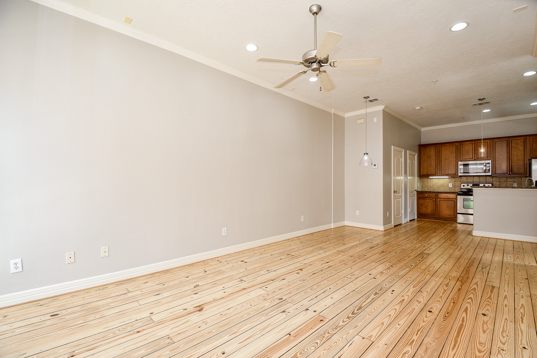 118 McGowen Street, Unit K Houston, TX 77006 - Photo 10 of 32 True open concept design with beautiful Pine wood floors in the living room with high ceilings cannister lights and lots of natural light