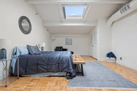 a bed room with a bed and a chair