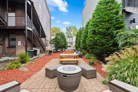 an outdoor sitting area with furniture and garden view