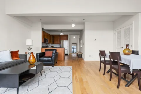 a living room with furniture and wooden floor