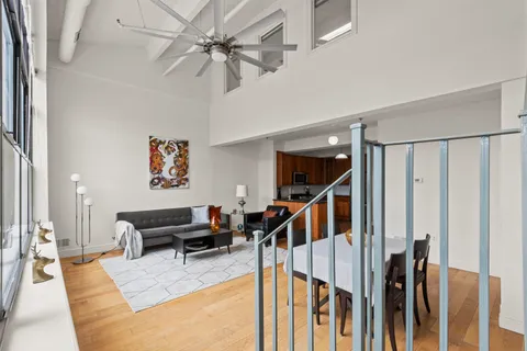 a living room with lots of furniture and a wooden floor
