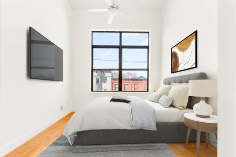 a bedroom with a bed and a window