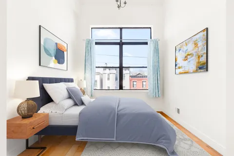 a bedroom with a bed and glass window
