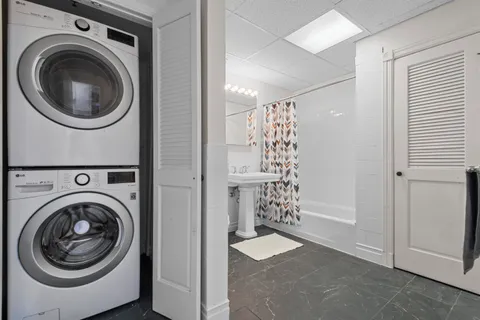 a view of a hallway with washer and dryer