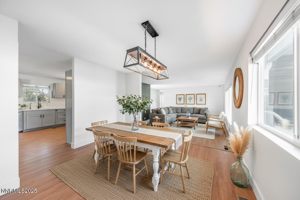 11675 Heartpine Street Reno, NV 89506 - Photo 11 of 38 a dining room with furniture a chandelier and wooden floor