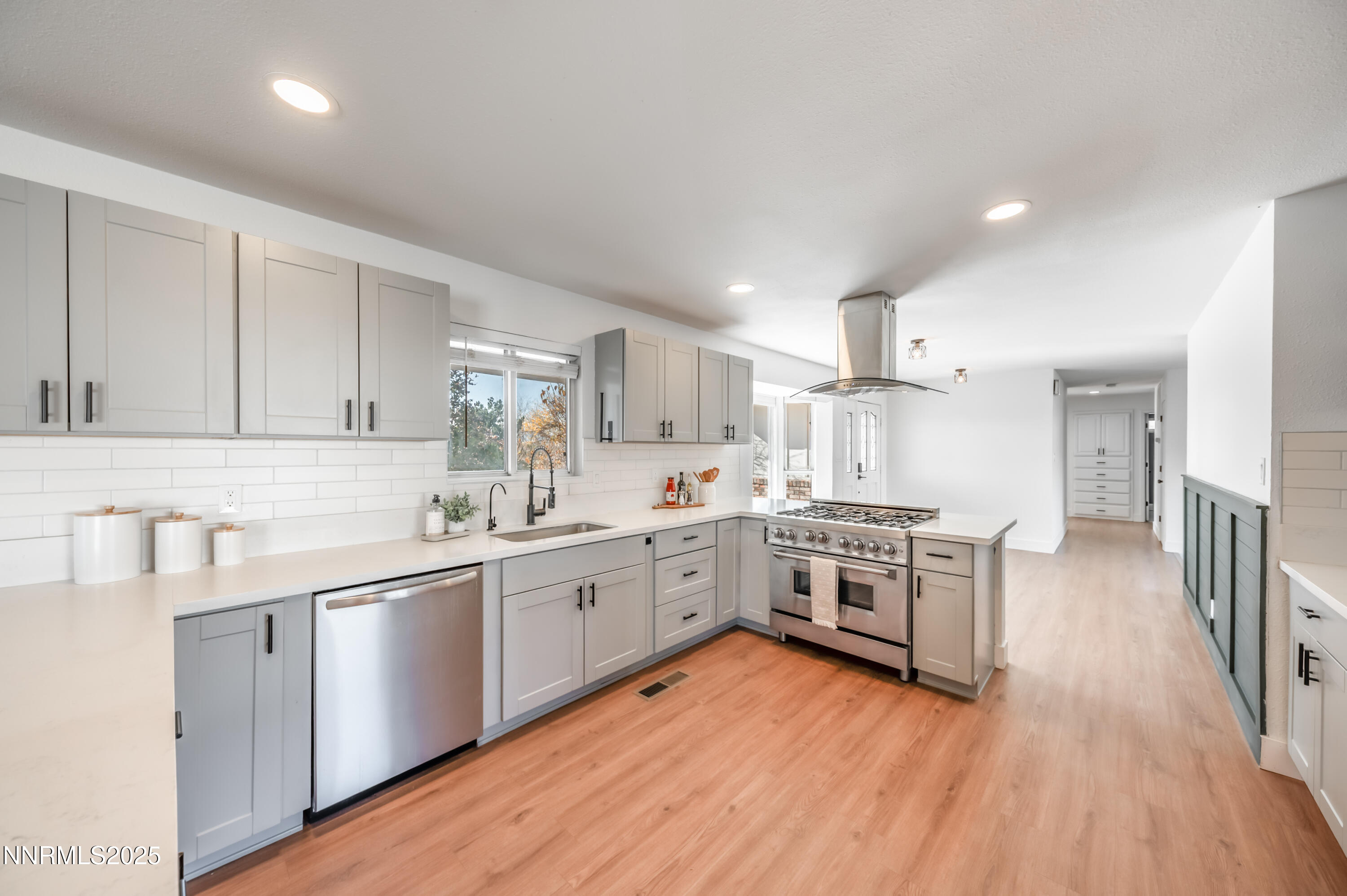 11675 Heartpine Street Reno, NV 89506 - Photo 6 of 38 a large kitchen with cabinets wooden floor and stainless steel appliances