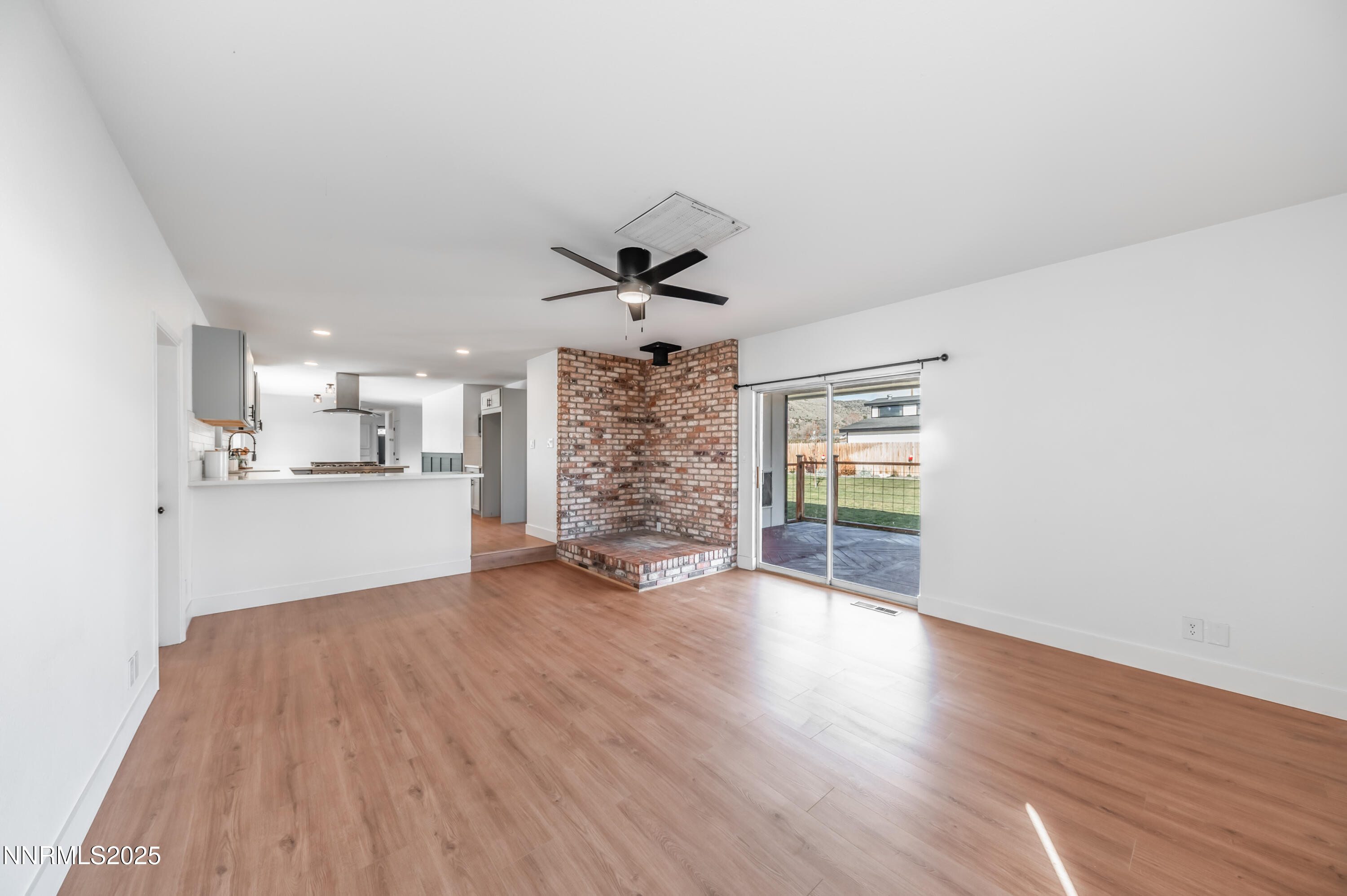 11675 Heartpine Street Reno, NV 89506 - Photo 8 of 38 a view of a big room with wooden floor and windows