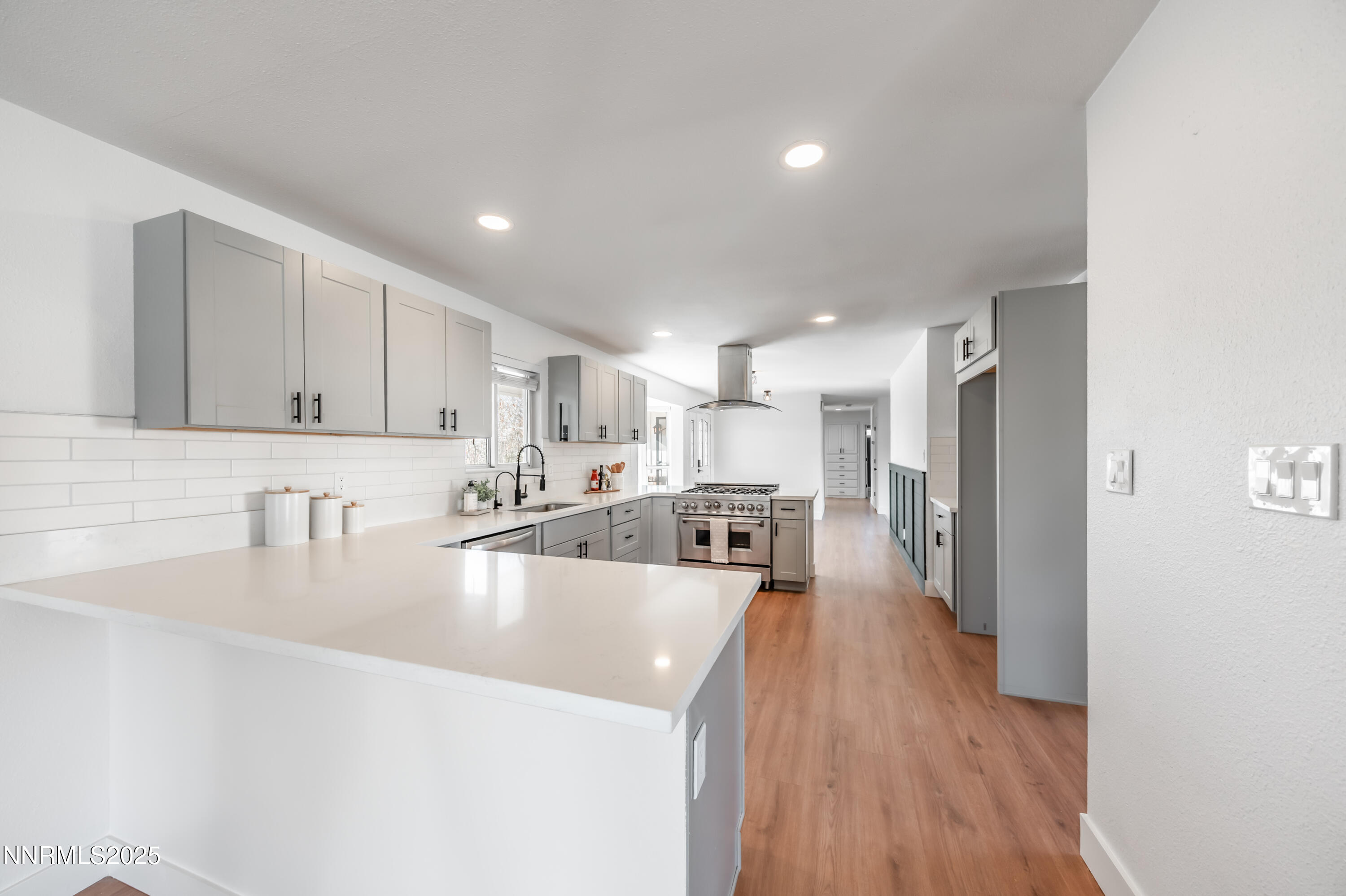 11675 Heartpine Street Reno, NV 89506 - Photo 9 of 38 a large kitchen with stainless steel appliances granite countertop a lot of counter space and wooden floors