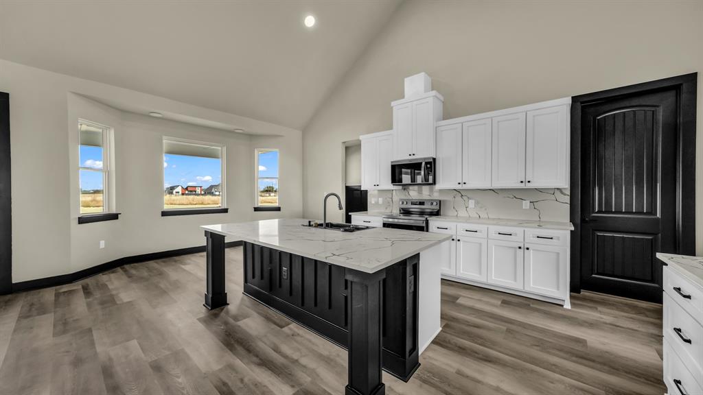 300 Jupiter Trail Weatherford, TX 76088 - Photo 12 of 33 a kitchen with sink cabinets and wooden floor
