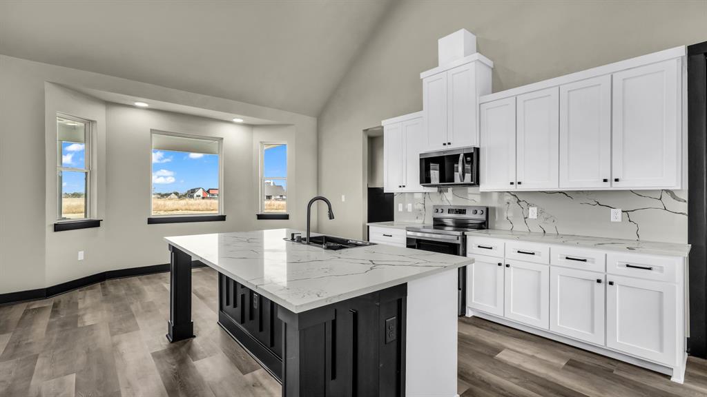 300 Jupiter Trail Weatherford, TX 76088 - Photo 14 of 33 a kitchen with granite countertop a stove and a sink