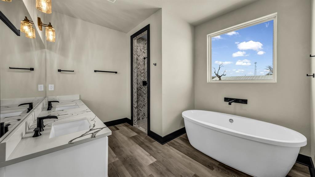 300 Jupiter Trail Weatherford, TX 76088 - Photo 28 of 33 a bathroom with a sink and bathtub with shower