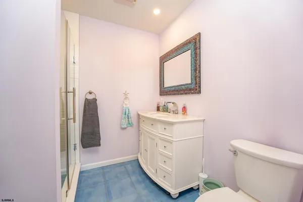 a bathroom with a sink toilet and mirror