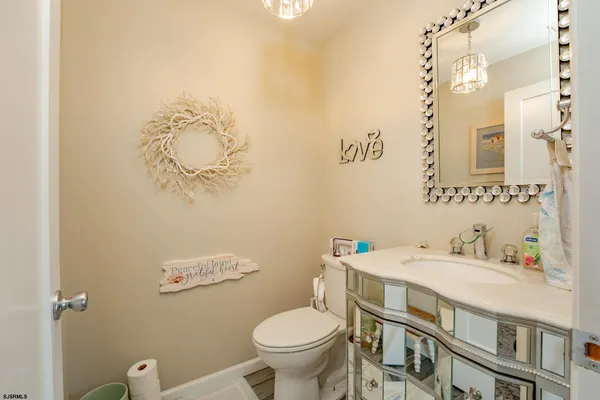 a bathroom with a sink mirror vanity and toilet