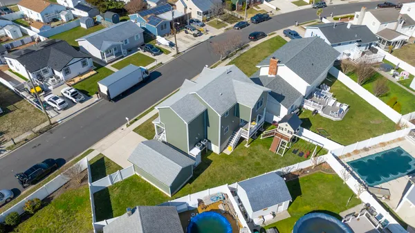 an aerial view of a house with a yard and outdoor seating