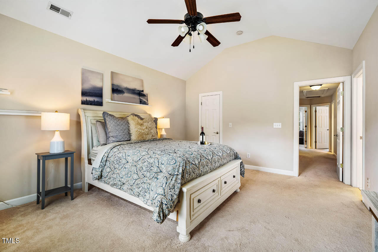 5515 South Roxboro Street, Unit 4 Durham, NC 27713 - Photo 15 of 34 a bedroom with a bed and ceiling fan