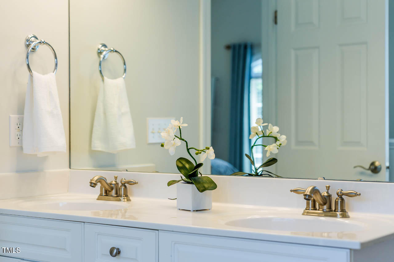 5515 South Roxboro Street, Unit 4 Durham, NC 27713 - Photo 21 of 34 a bathroom with a sink a vanity and a mirror