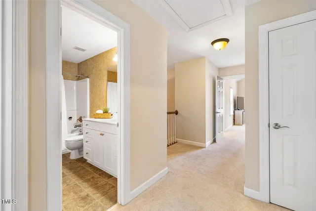 a view of a hallway with bathroom and a bathroom
