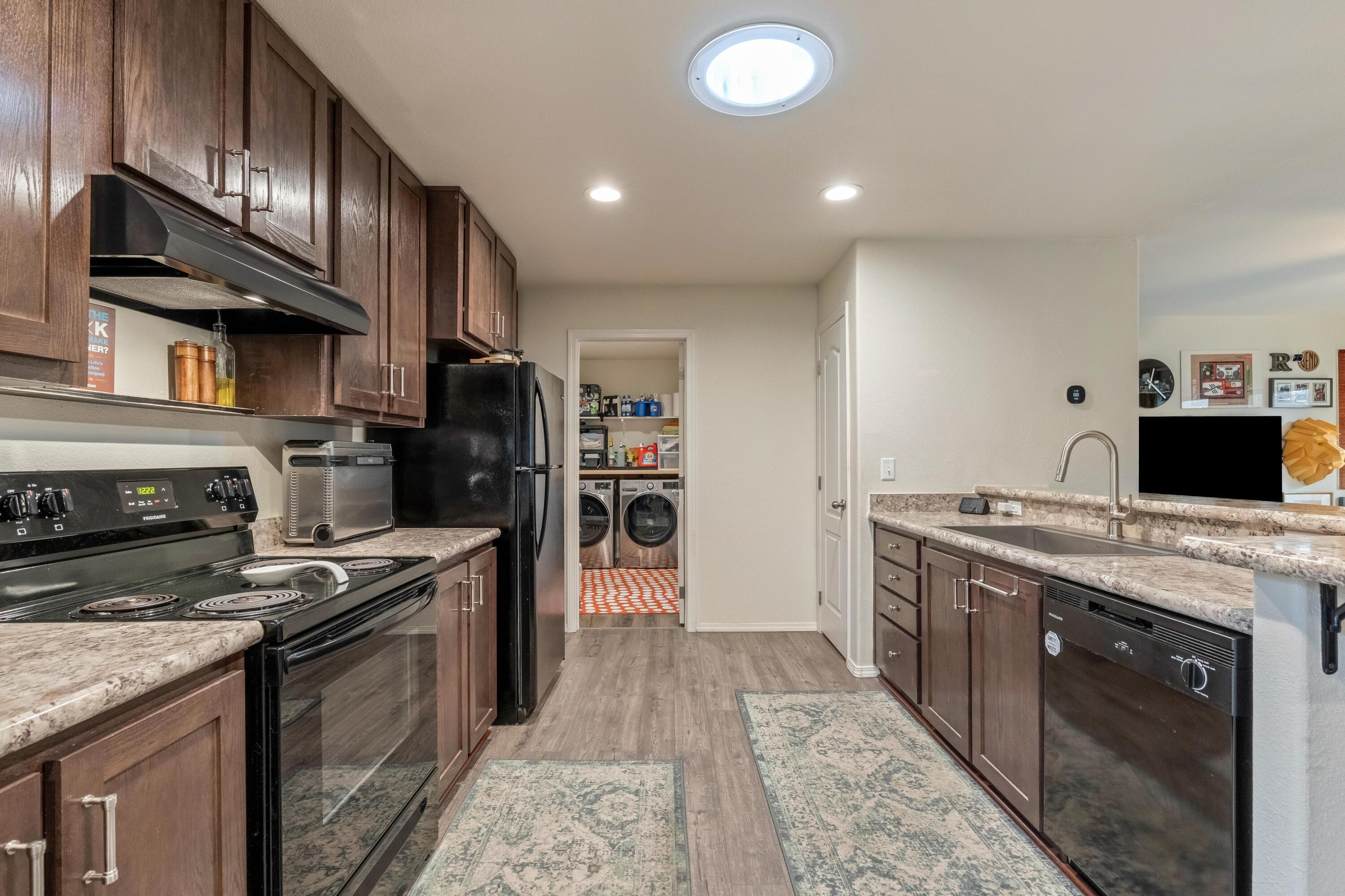 55823 Snow Goose Road Bend, OR 97707 - Photo 8 of 36 a kitchen with stainless steel appliances granite countertop a stove a sink and a refrigerator