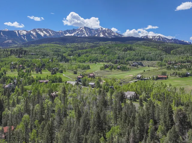a view of a town with mountains in the background