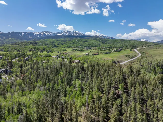 a view of a balcony with a yard