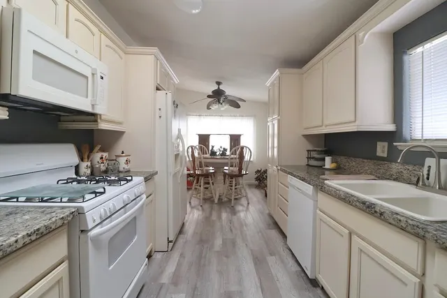 a kitchen with a stove sink and cabinets