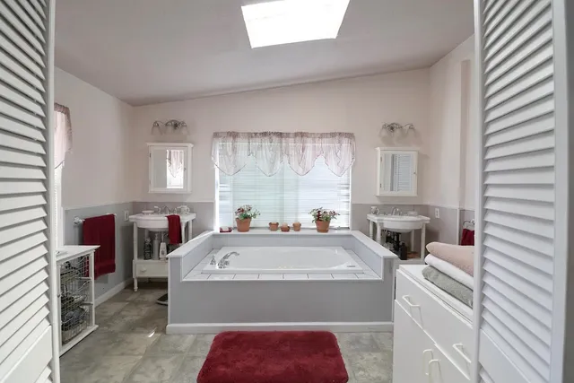 a living room with furniture a fireplace and large windows