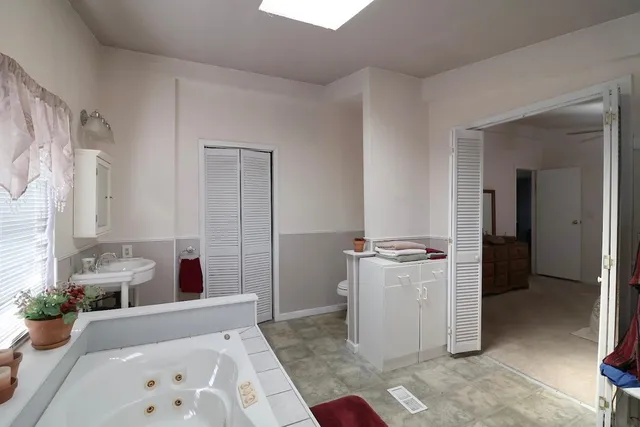 a bed room with a bed and a view of living room