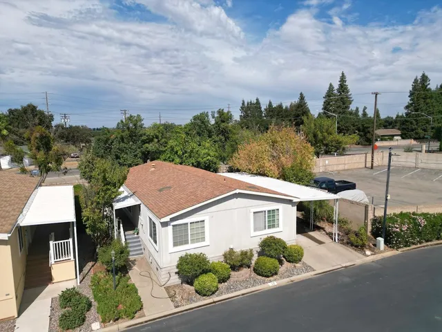 a aerial view of a house next to a yard