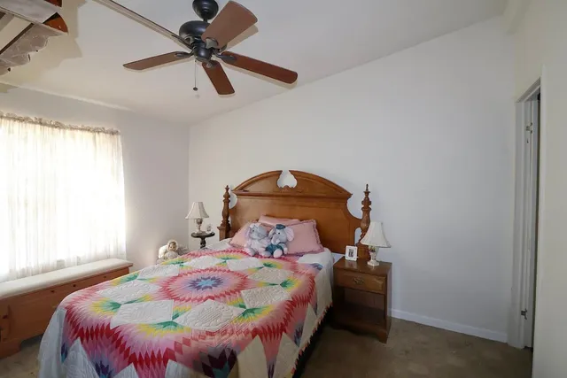 a bedroom with a bed and window