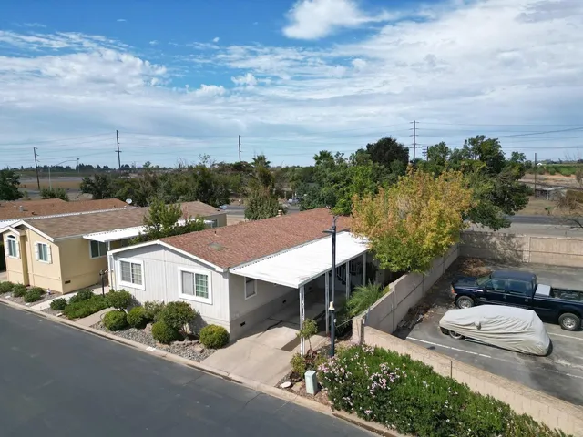 an aerial view of a house with swimming pool and green space