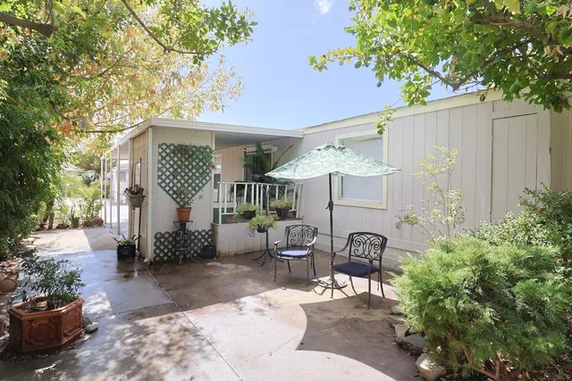 a building outdoor space with patio furniture and potted plants