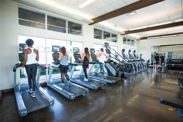 a view of a room with lots of gym equipment