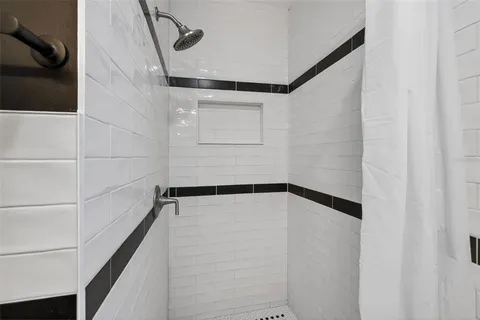 a living room with furniture a large window and a table