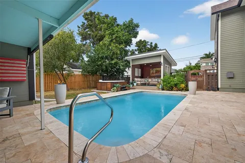 a view of a house with sitting area and garden