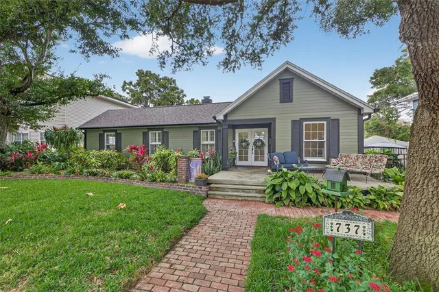 a front view of a house with a garden