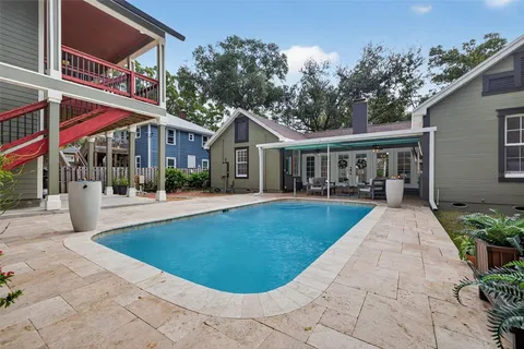 a kitchen with kitchen island granite countertop a refrigerator and a sink
