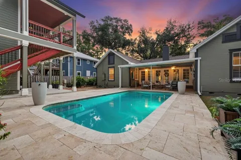 a kitchen with cabinets stainless steel appliances and wooden floor