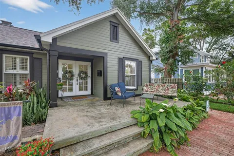 a view of a house with sitting area and garden