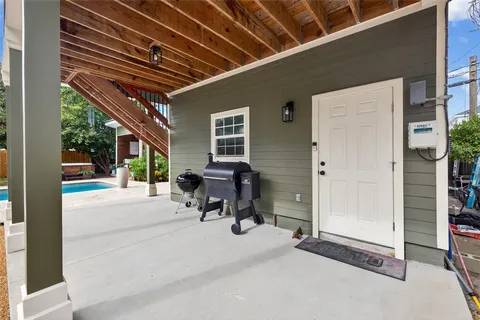 a kitchen with stainless steel appliances granite countertop white cabinets a sink a stove a window and dishwasher