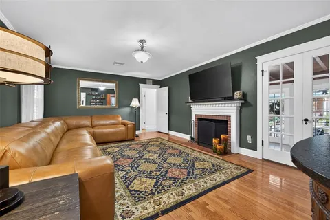 a living room with furniture flat screen tv and a fireplace
