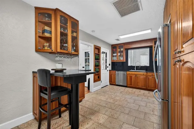 a living room with a couch and a dresser next to a window