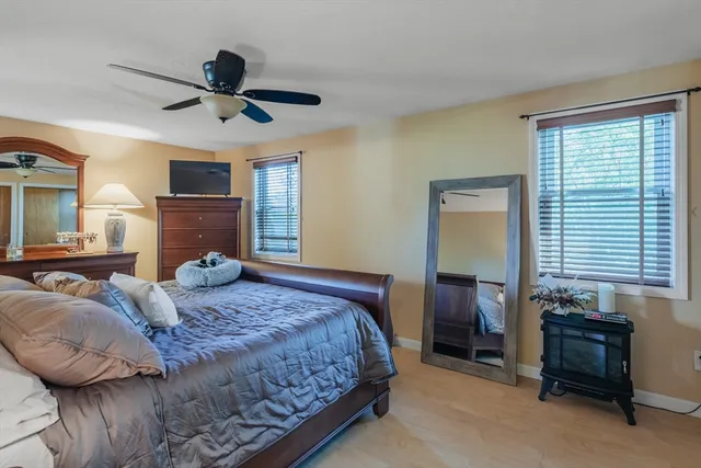 a bedroom with a large bed and a window