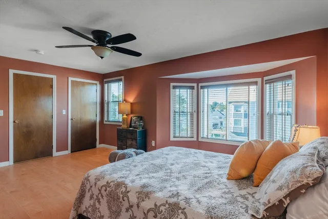 a bedroom with a large bed and a large window