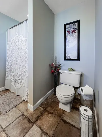 a white toilet sitting next to a bathroom sink
