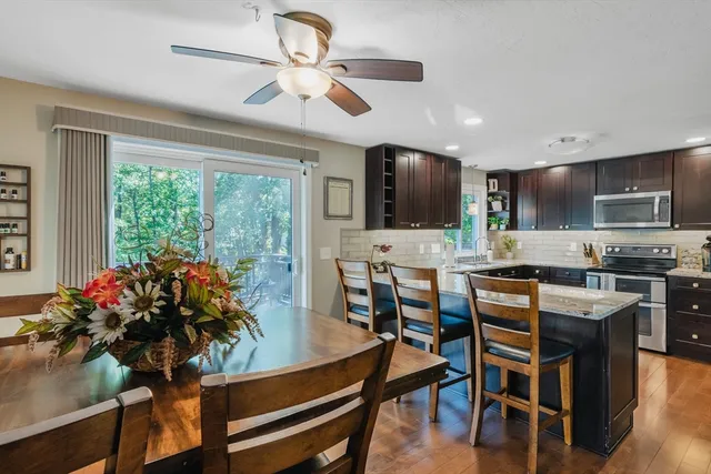 a view of a dining room with furniture window and wooden floor