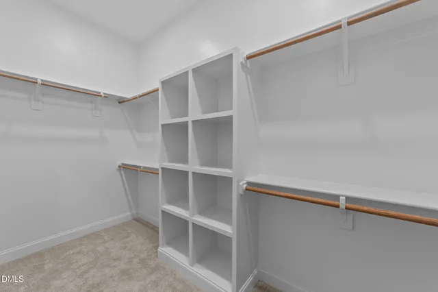 a room with a door open and a microwave