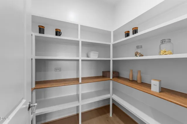 a spacious bedroom with a bed and a chandelier