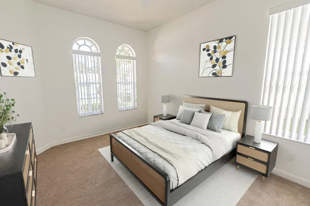 a bedroom with a bed and a window