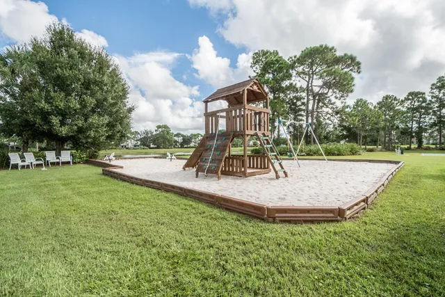a view of outdoor space with playground and green space
