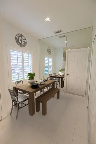 a room with a table chairs and projector